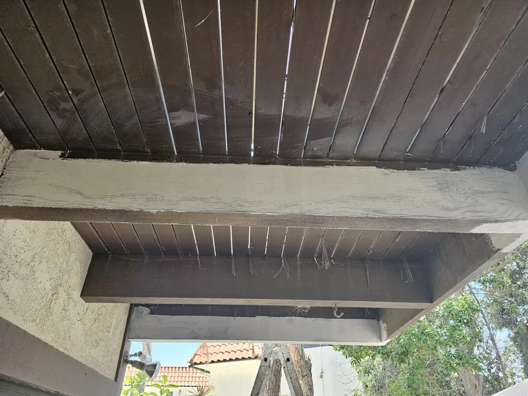 The same deck beam after repair, with missing areas rebuilt and a light repair surface